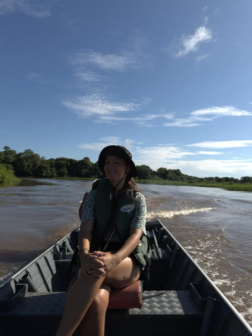 A guest on a boat safari on the river