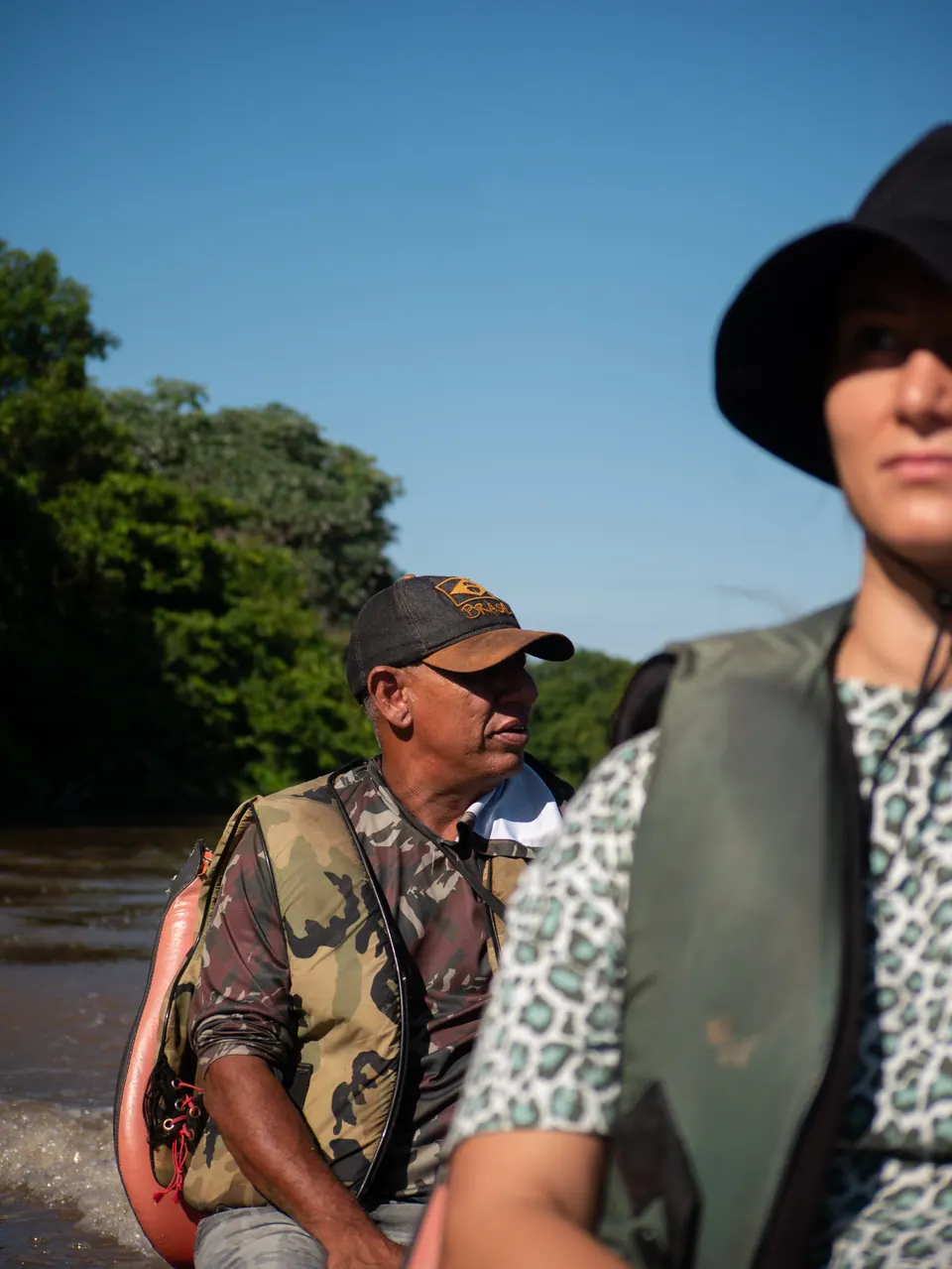 Guide and guest scanning the riverbank