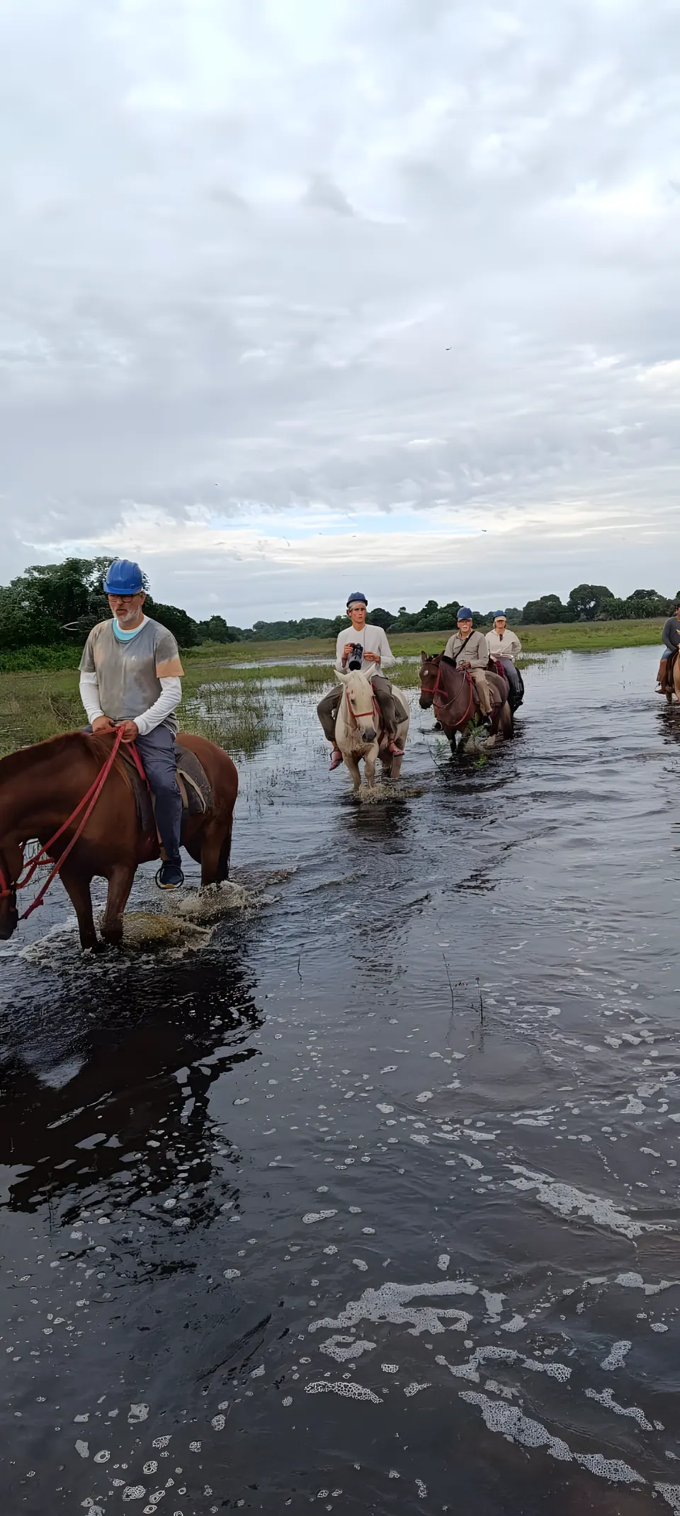 Horseback riding through shallow water