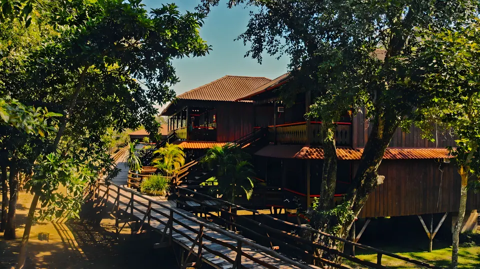Wooden riverside lodge among the trees