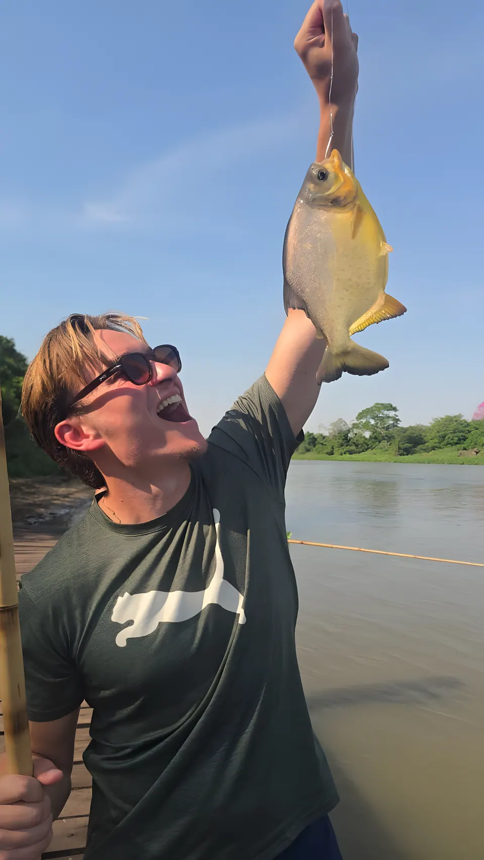 A guest holding up a piranha