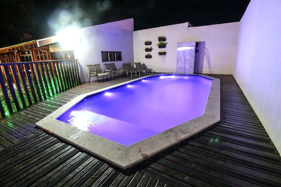 Swimming pool with sun loungers at Pousada Remanso