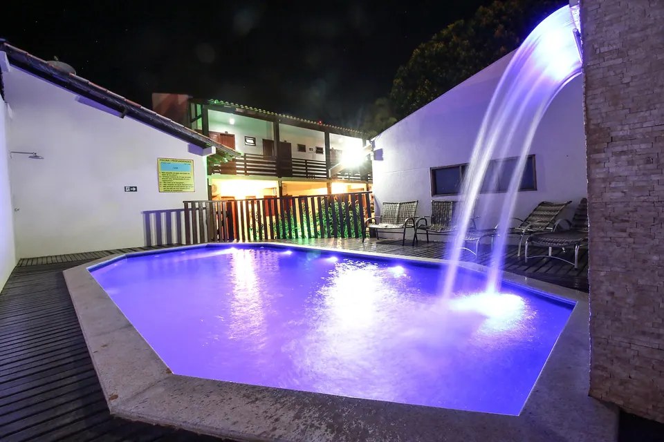 The pool and waterfall at Pousada Remanso, lit at night